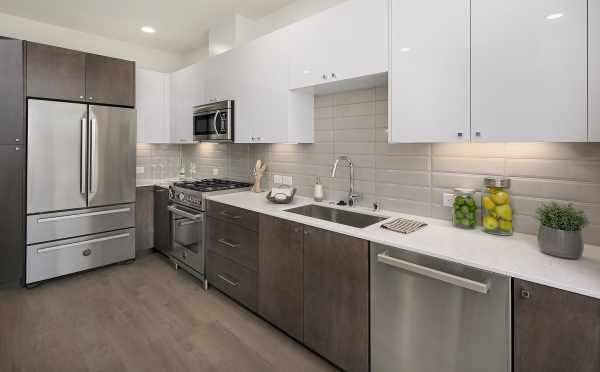 Kitchen with Quartz Counters and Stainless Steel Appliances in the Avani Townhomes