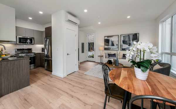 View from the Dining Room to the Kitchen and Living Room at 10419 Alderbrook Pl NW in the Flora Collection at Greenwood