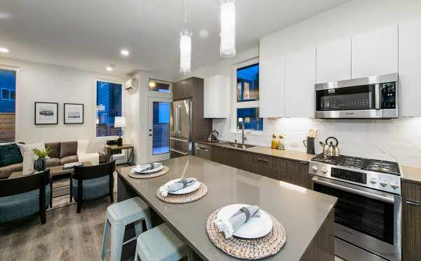 View from the Kitchen to the Living Room at 10447 Alderbrook Pl NW, One of the Hyacinth Homes in the Flora Collection