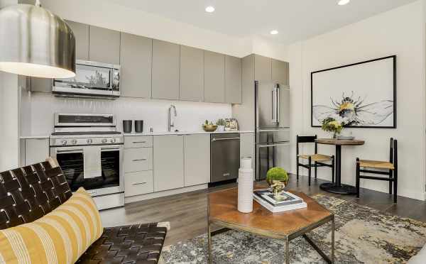 View of the Dining Area and Kitchen from the Living Area at 8364 14th Ave NW, One of the Thoren Townhomes in Crown Hill